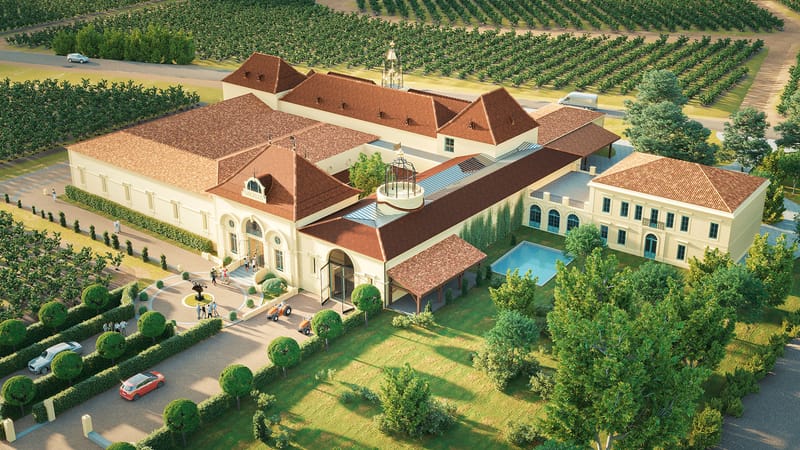 Vue globale d'un grand domaine viticole aux toits de tuiles rouges entouré de vignes, Château Angélus à Saint-Émilion