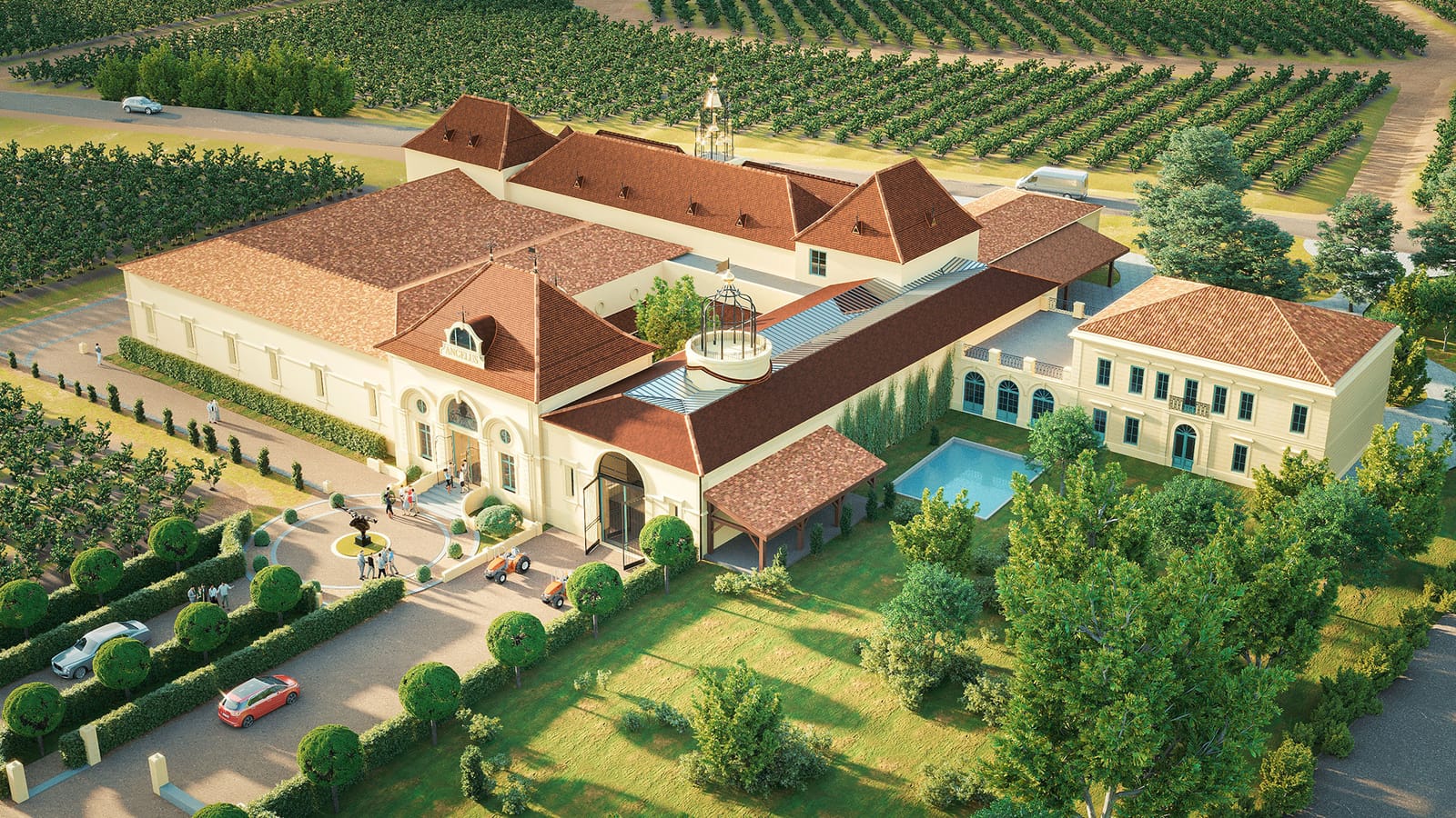 Vue globale d'un grand domaine viticole aux toits de tuiles rouges entouré de vignes, Château Angélus à Saint-Émilion