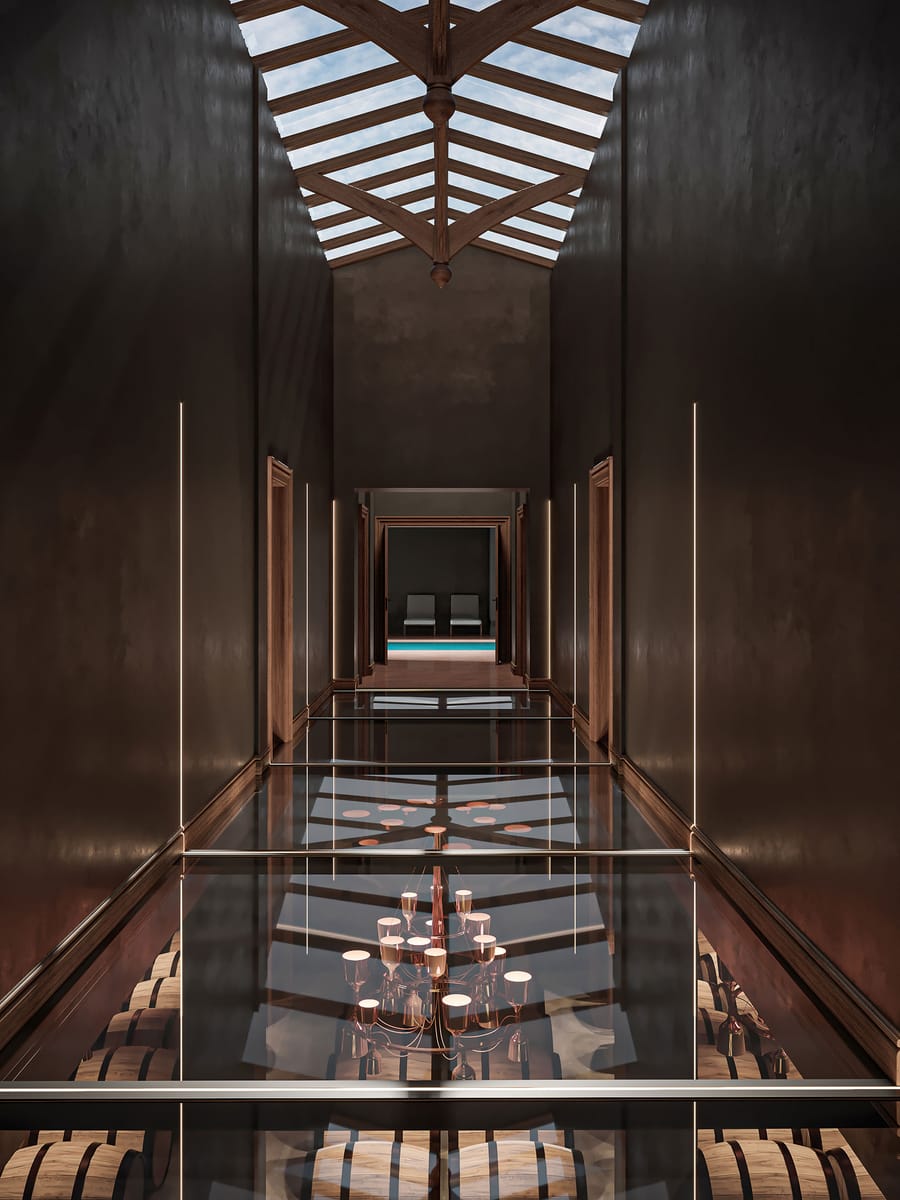 Couloir au plancher de verre surplombant un chai à barriques et un lustre, dans un domaine viticole, Château Guiraud à Sauternes