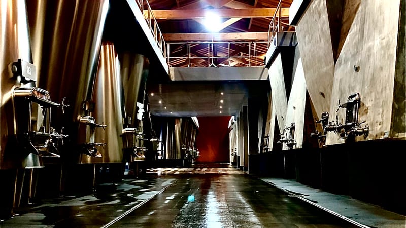 Elevated view of the inner courtyard of a stone winery surrounded by vineyards, Château Laffitte Carcasset in Saint-Estèphe