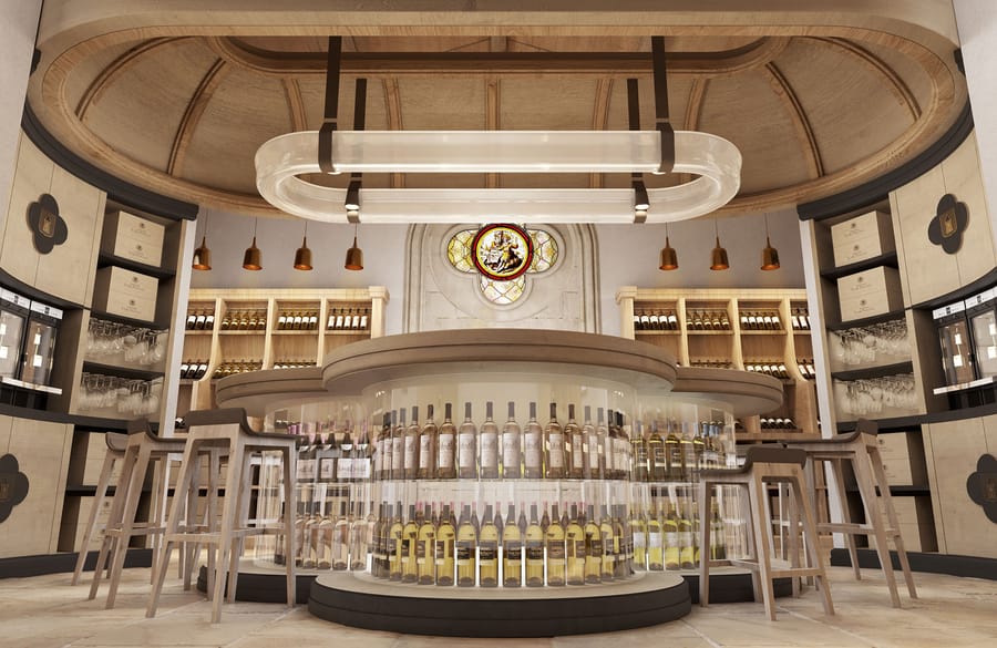 Bar circulaire de dégustation aménagé avec vitrines de bouteilles et tabourets hauts en bois dans une cave, Château Tour Prignac dans le Médoc