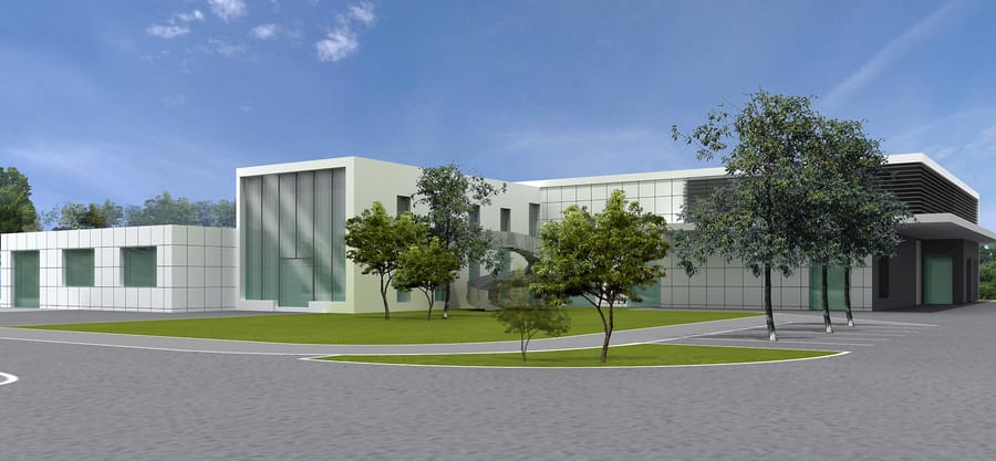 Façade d'un bâtiment d'entreprise moderne aux larges baies vitrées entouré d'espaces verts et d'arbres, Merck Biodevelopment à Martillac