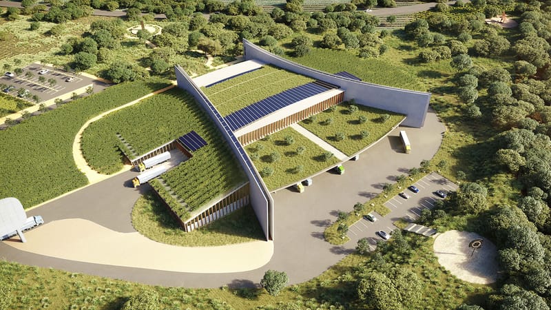 Vue aérienne d'un bâtiment moderne aux toits végétalisés équipés de panneaux solaires dans un cadre verdoyant