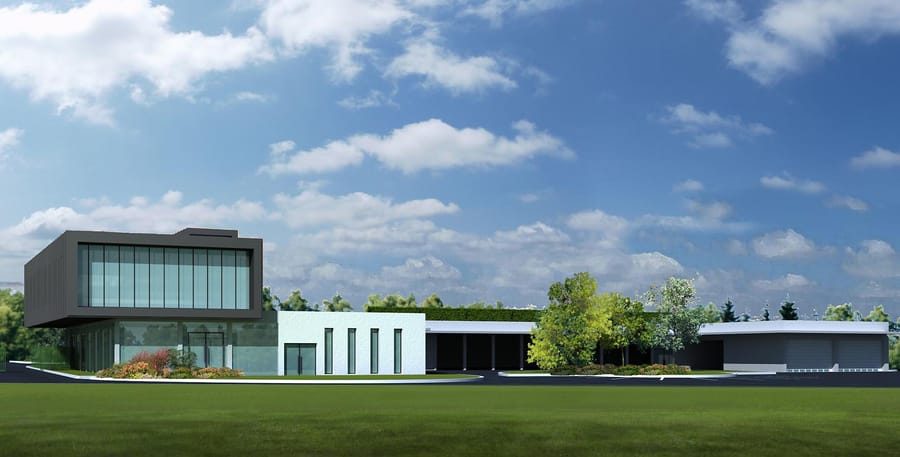 Bâtiment d'entreprise à l'architecture contemporaine avec de grandes baies vitrées et des espaces verts, à Mailly-le-Camp